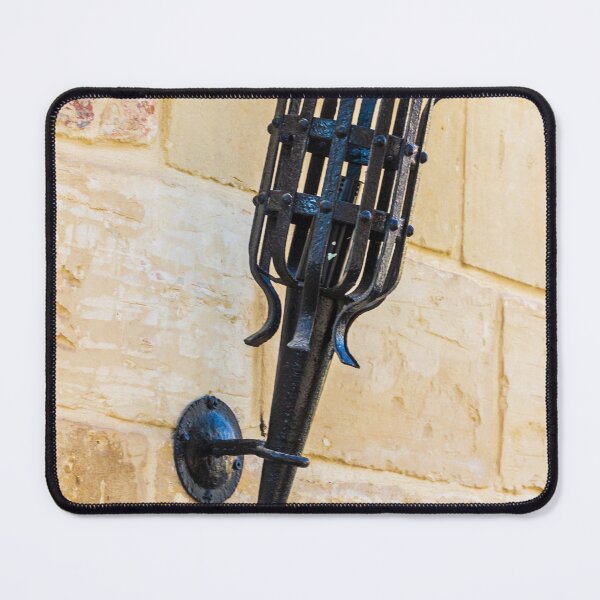 Item preview, Antique Black Iron Wall Torch with Spiked Holder Mounted on Rustic Stone Wall designed and sold by Nmallia.