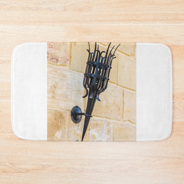 Item preview, Antique Black Iron Wall Torch with Spiked Holder Mounted on Rustic Stone Wall designed and sold by Nmallia.
