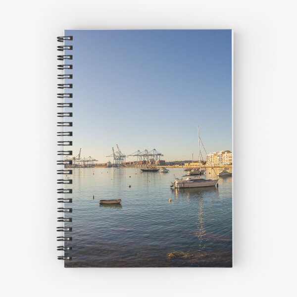 Item preview, Scenic Harbor With Boats and Calm Sea at Sunset Over Coastal Town Waterfront designed and sold by Nmallia.
