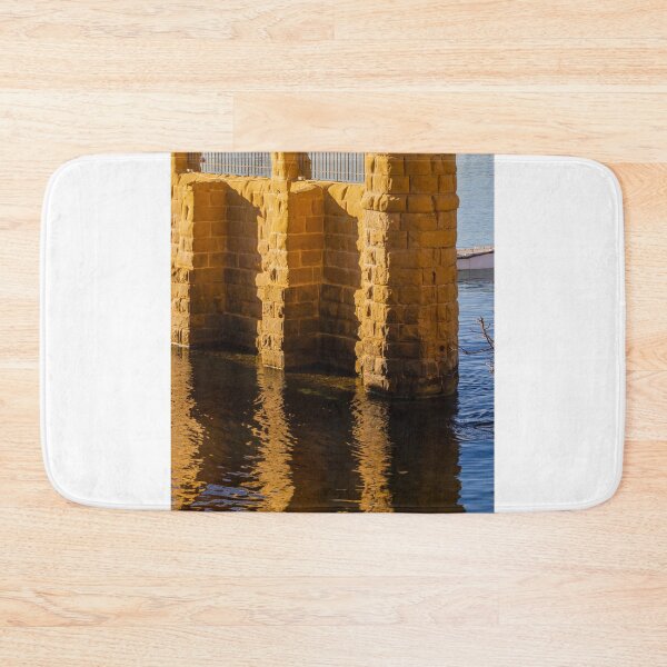 Item preview, Golden Stone Pillars by Calm Harbor Water with Reflective Surface and Sunlit Brick Wall designed and sold by Nmallia.