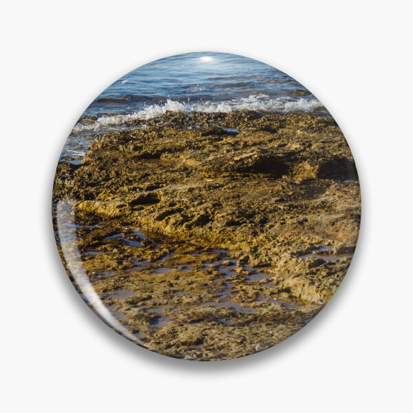 Item preview, Rugged Coastal Rocks By Calm Blue Water With Weathered Stone Pier And Small Post designed and sold by Nmallia.
