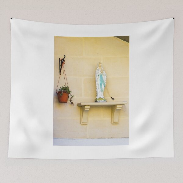 Item preview, Statue Of Virgin Mary On Shelf Beside Hanging Plant Against Light Beige Wall designed and sold by Nmallia.