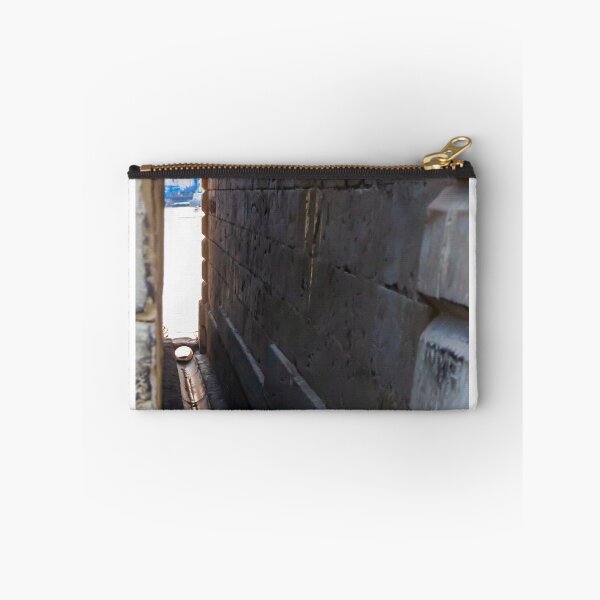 Item preview, Narrow Stone Dockside Gap With Water Channel and Industrial Harbor Visible in Background designed and sold by Nmallia.