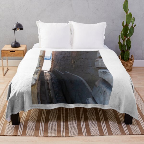 Item preview, Narrow Stone Dockside Gap With Water Channel and Industrial Harbor Visible in Background designed and sold by Nmallia.