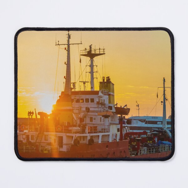 Item preview, Red Cargo Ship Docked at Harbor During Golden Sunset With Industrial Port Cranes in Background designed and sold by Nmallia.