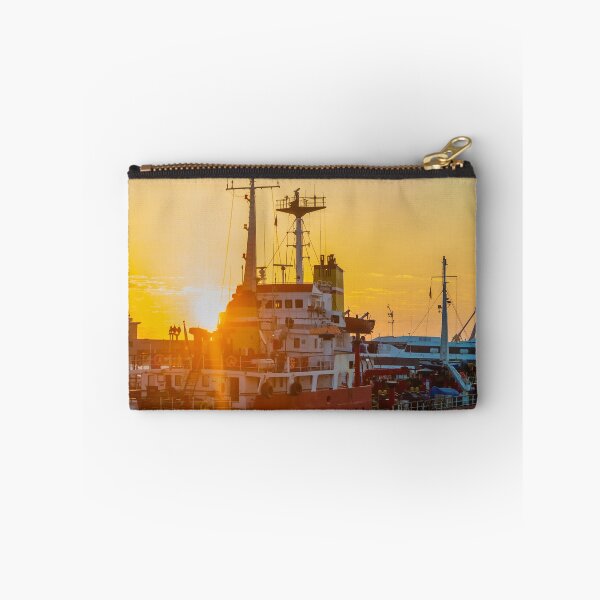 Item preview, Red Cargo Ship Docked at Harbor During Golden Sunset With Industrial Port Cranes in Background designed and sold by Nmallia.