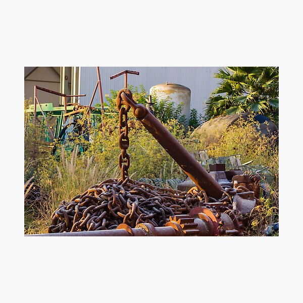 Item preview, Rusted Anchor and Heavy Chain Amid Overgrown Industrial Scrapyard With Machinery and Plants designed and sold by Nmallia.