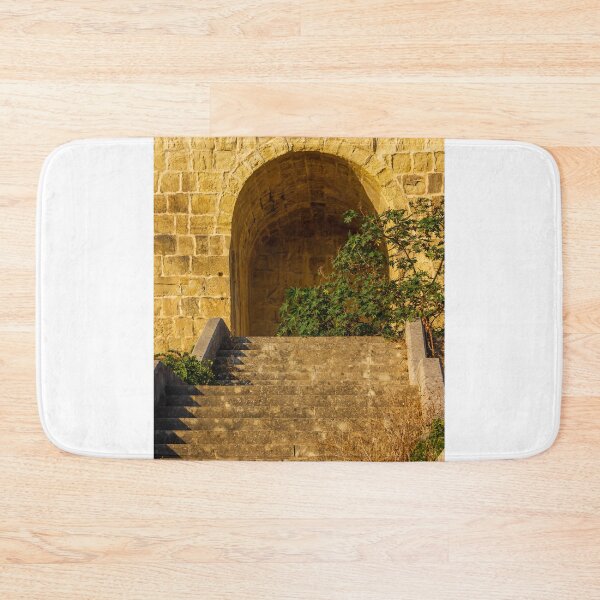 Item preview, Stone Stairs Leading to Historic Stone Archway and Sunlit Wall With Green Foliage designed and sold by Nmallia.