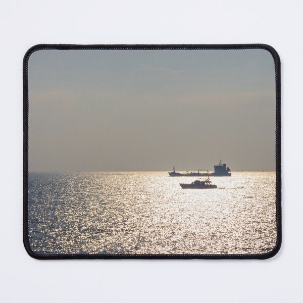 Item preview, Sunlit Ocean Horizon With Silhouetted Cargo Ship And Motorboat Crossing Glittering Water designed and sold by Nmallia.