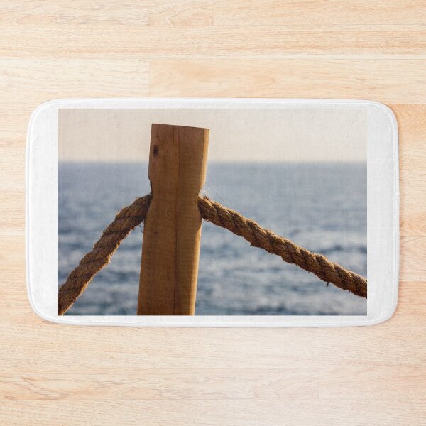 Item preview, Weathered Wooden Post and Thick Rope Railing Overlooking Calm Ocean at Sunset Seaside Boardwalk designed and sold by Nmallia.