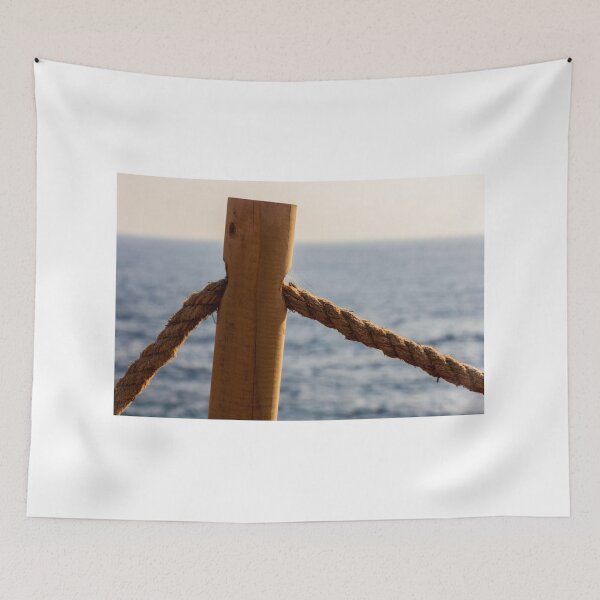 Item preview, Weathered Wooden Post and Thick Rope Railing Overlooking Calm Ocean at Sunset Seaside Boardwalk designed and sold by Nmallia.