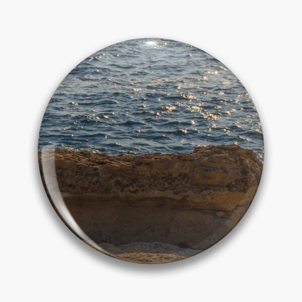 Item preview, Sunlit Coastal Rock Ledge Over Calm Ocean Waves With Sparkling Water at Sunset designed and sold by Nmallia.