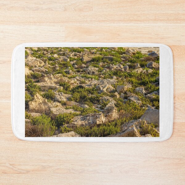 Item preview, Rocky Coastal Terrain With Low Green Shrubs and Sunlit Limestone Boulders designed and sold by Nmallia.