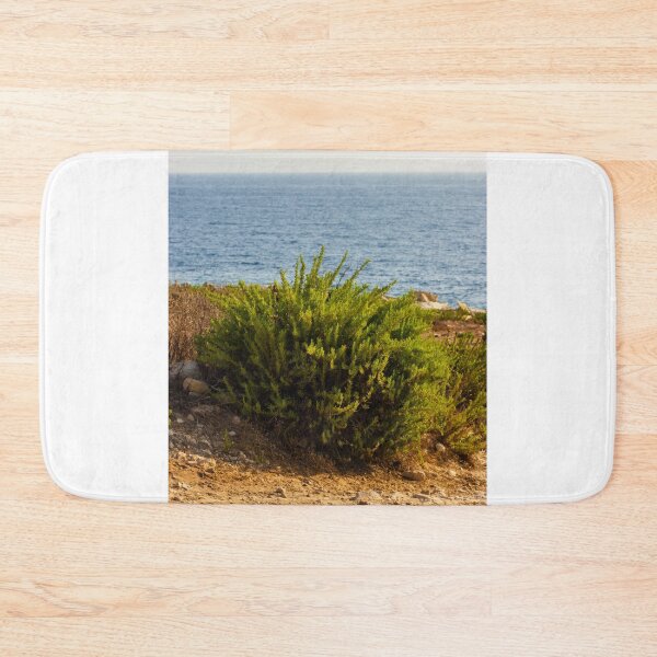 Item preview, Coastal Shrub On Rocky Cliff Overlooking Calm Blue Sea On Sunny Summer Day designed and sold by Nmallia.
