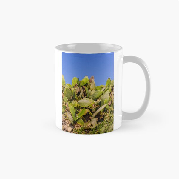 Item preview, Sunlit Prickly Pear Cactus Cluster Against Clear Blue Sky On Rocky Coastal Landscape designed and sold by Nmallia.