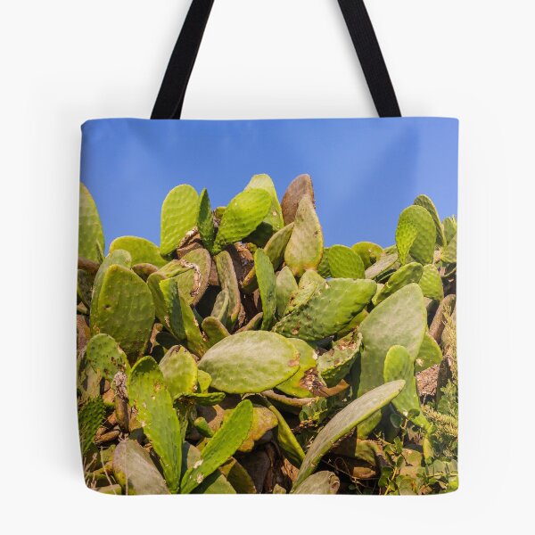 Item preview, Sunlit Prickly Pear Cactus Cluster Against Clear Blue Sky On Rocky Coastal Landscape designed and sold by Nmallia.