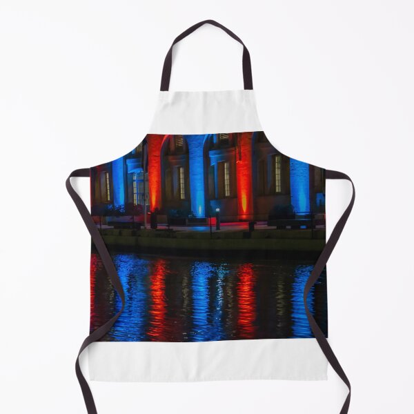Item preview, Nighttime Waterfront Building With Red And Blue Illuminated Arches And Reflections On Water designed and sold by Nmallia.