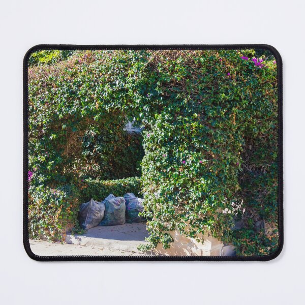Item preview, Overgrown Ivy Arch Forms a Secluded Green Entrance Beside Trash Bags designed and sold by Nmallia.
