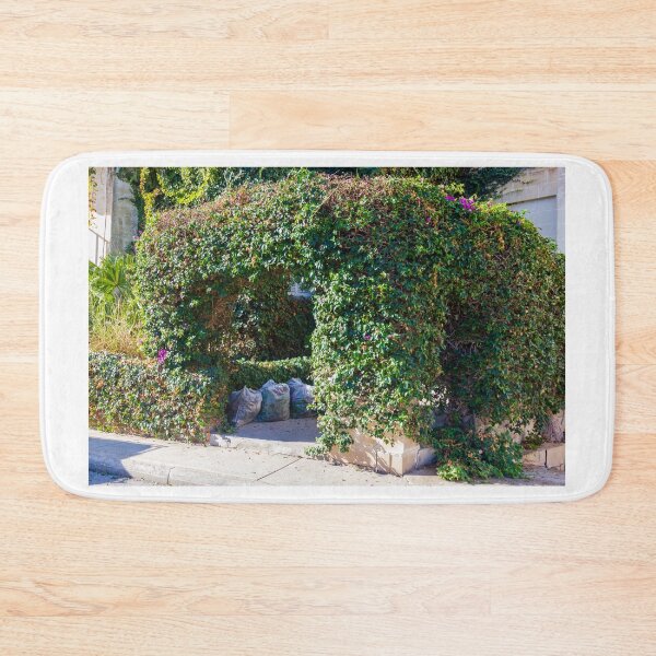 Item preview, Overgrown Ivy Arch Forms a Secluded Green Entrance Beside Trash Bags designed and sold by Nmallia.