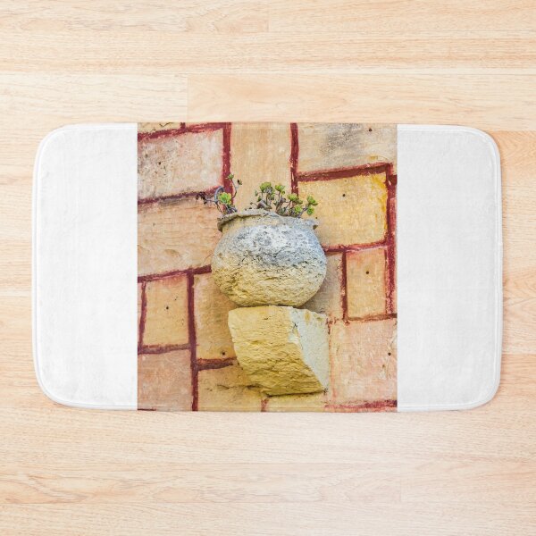 Item preview, Ancient Stone Planter with Succulent Plants Mounted on a Warm, Sunlit Terracotta Wall designed and sold by Nmallia.