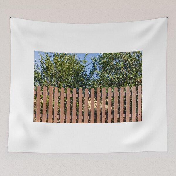 Item preview, Brown Wooden Picket Fence With Lush Greenery Behind In Sunny Outdoor Yard Near Olive Trees designed and sold by Nmallia.