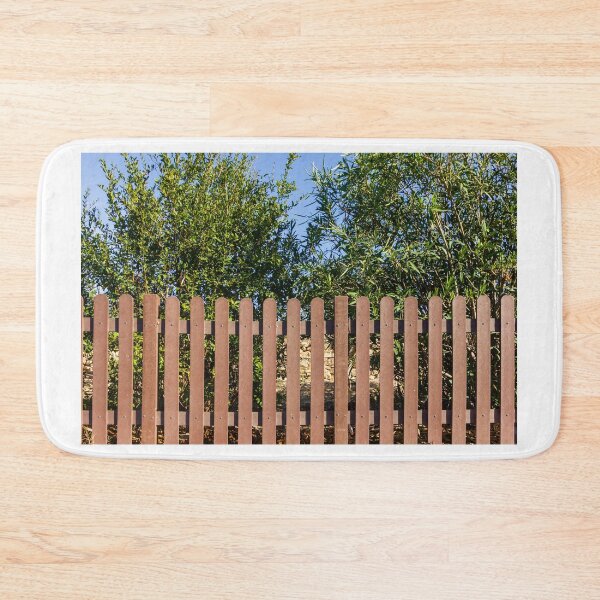 Item preview, Brown Wooden Picket Fence With Lush Greenery Behind In Sunny Outdoor Yard Near Olive Trees designed and sold by Nmallia.
