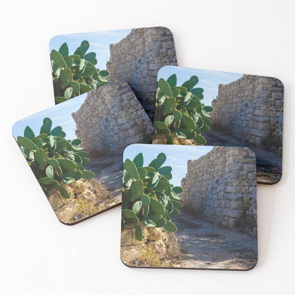 Item preview, Ancient Stone Wall Along a Desert Path with Cactus Plants Under Clear Sky designed and sold by Nmallia.