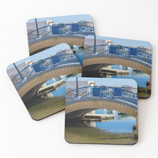 Item preview, Blue Arch Bridge Over Calm Harbor Water With City Buildings In Background designed and sold by Nmallia.