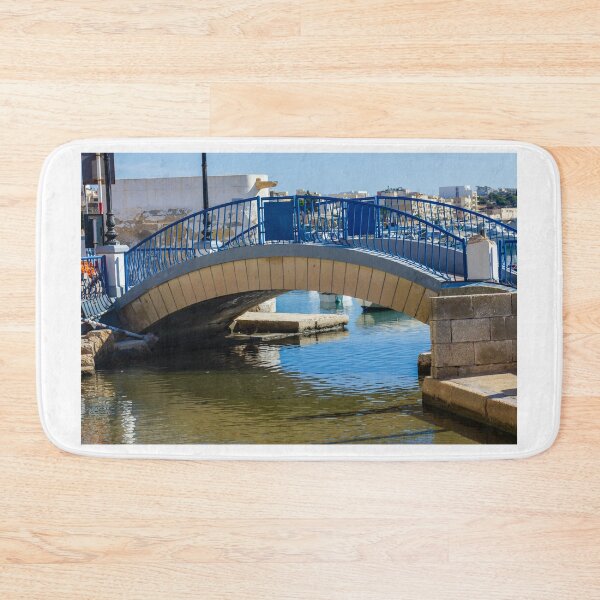 Item preview, Blue Arch Bridge Over Calm Harbor Water With City Buildings In Background designed and sold by Nmallia.