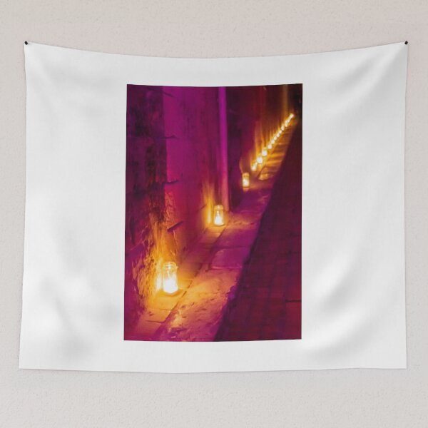 Item preview, Candlelit Alley At Night With Purple And Orange Hue, Warm Lanterns Along Stone Wall Glow designed and sold by Nmallia.