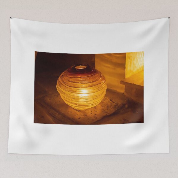 Item preview, Warm Amber Lantern Sits on Sandy Ground Providing Cozy Indoor-Outdoor Glow and Decor designed and sold by Nmallia.