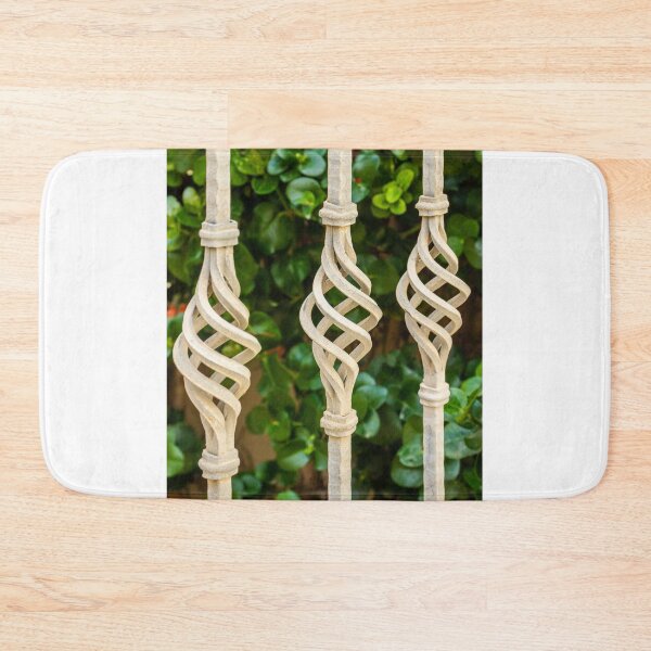 Item preview, Decorative Twisted Iron Fence Bars With Vertical Rods Over Lush Green Hedge Behind Wall designed and sold by Nmallia.