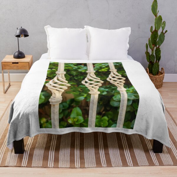 Item preview, Decorative Twisted Iron Fence Bars With Vertical Rods Over Lush Green Hedge Behind Wall designed and sold by Nmallia.