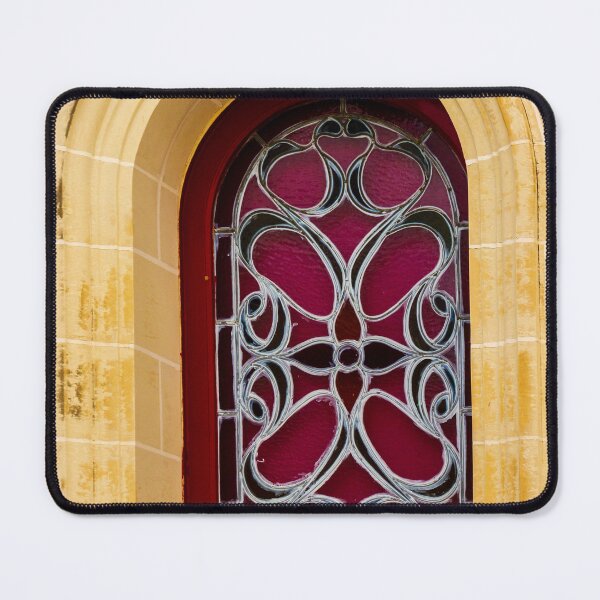 Item preview, Elegant Arched Stained Glass Window With Intricate Ironwork On Warm Stone Facade designed and sold by Nmallia.