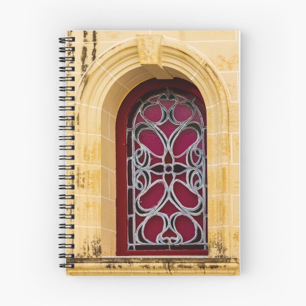 Item preview, Elegant Arched Stained Glass Window With Intricate Ironwork On Warm Stone Facade designed and sold by Nmallia.