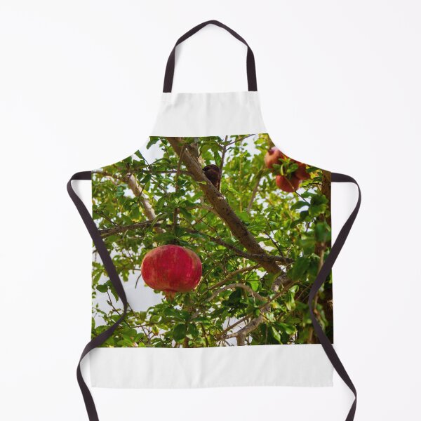 Item preview, Vibrant Red Pomegranate Hanging From Lush Green Tree Branches in a Sunlit Orchard designed and sold by Nmallia.