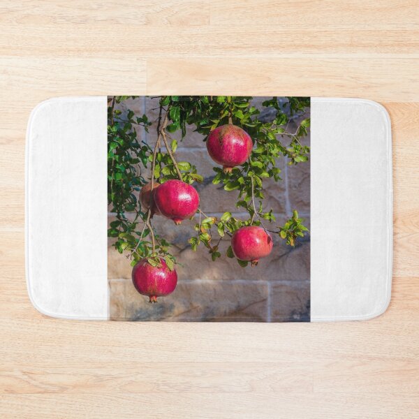 Item preview, Vibrant Red Pomegranate Hanging From Lush Green Tree Branches in a Sunlit Orchard designed and sold by Nmallia.