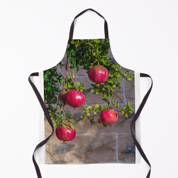 Item preview, Vibrant Red Pomegranate Hanging From Lush Green Tree Branches in a Sunlit Orchard designed and sold by Nmallia.