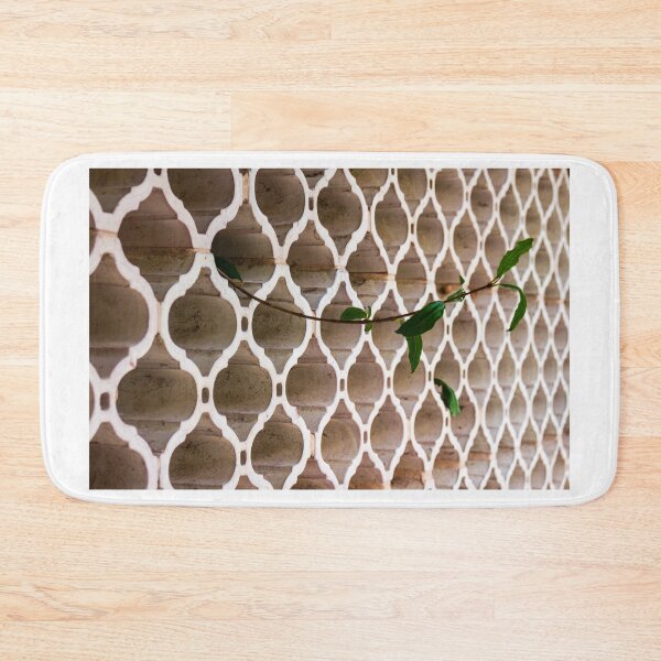Item preview, Vines Climb Through White Lattice Fence Against Aged Brick Wall In Sunlight designed and sold by Nmallia.