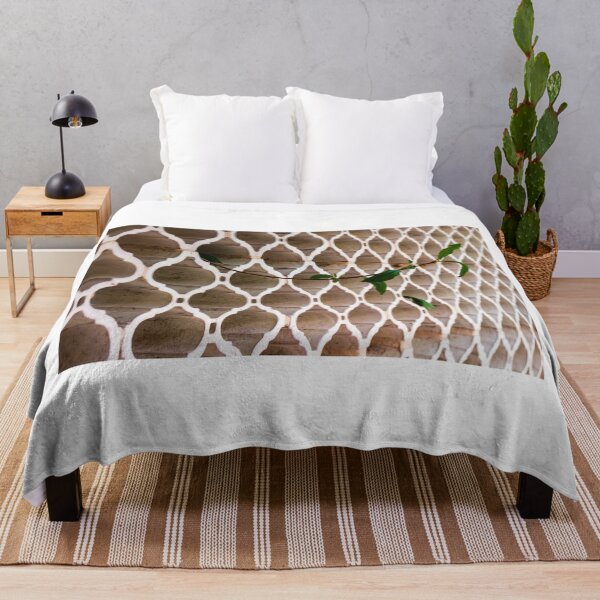 Item preview, Vines Climb Through White Lattice Fence Against Aged Brick Wall In Sunlight designed and sold by Nmallia.