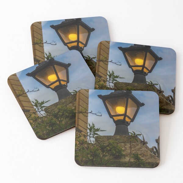 Item preview, Vintage Streetlamp With Warm Glow Over Stone Wall Amid Ivy And Evening Sky designed and sold by Nmallia.