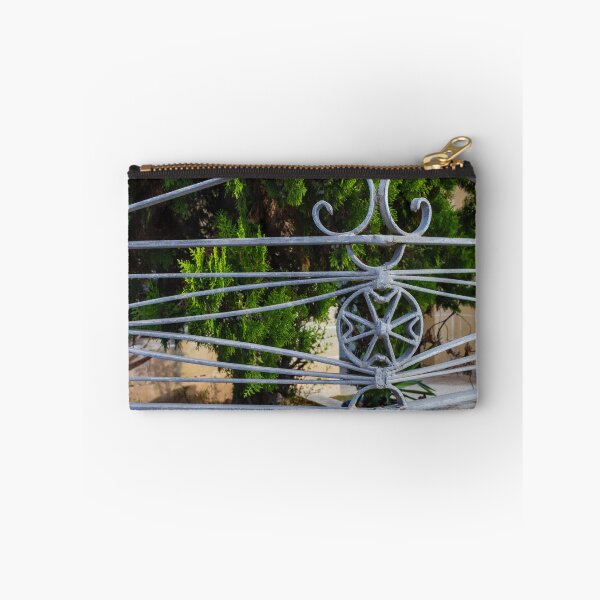 Item preview, Ornate Wrought Iron Gate Railings With Star Medallion Against Lush Greenery designed and sold by Nmallia.