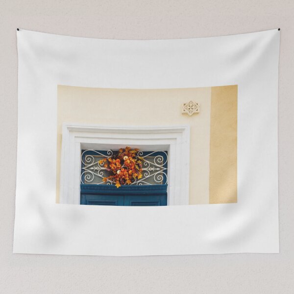Item preview, Autumn Wreath Adorns Blue Door With White Ornate Grille On Sunlit Wall designed and sold by Nmallia.
