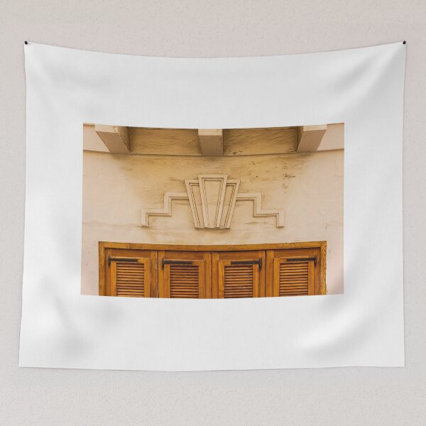 Item preview, Art Deco Stone Motif Above Warm Wooden Shuttered Door on Cream Facade, Historic Urban Architecture Detail designed and sold by Nmallia.
