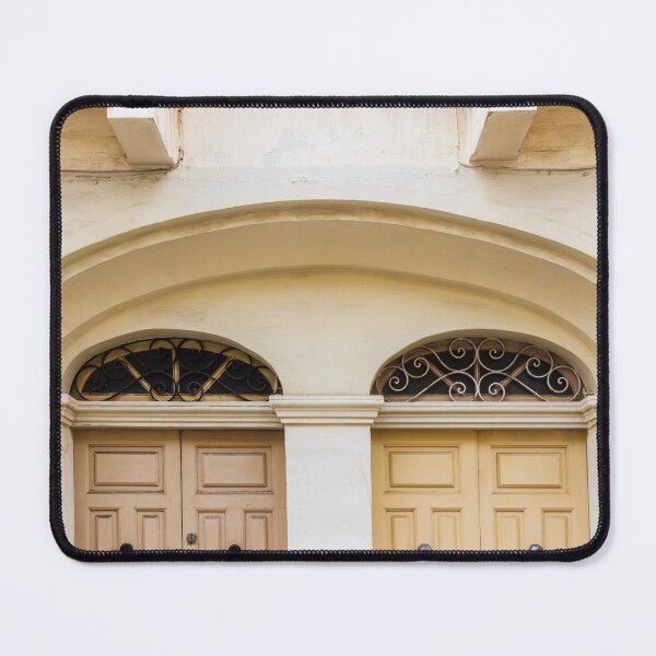 Item preview, Double Wooden Doors Under Archway With Decorative Iron Grilles On Cream Facade designed and sold by Nmallia.