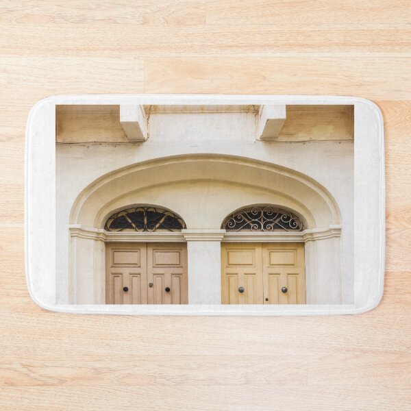 Item preview, Double Wooden Doors Under Archway With Decorative Iron Grilles On Cream Facade designed and sold by Nmallia.