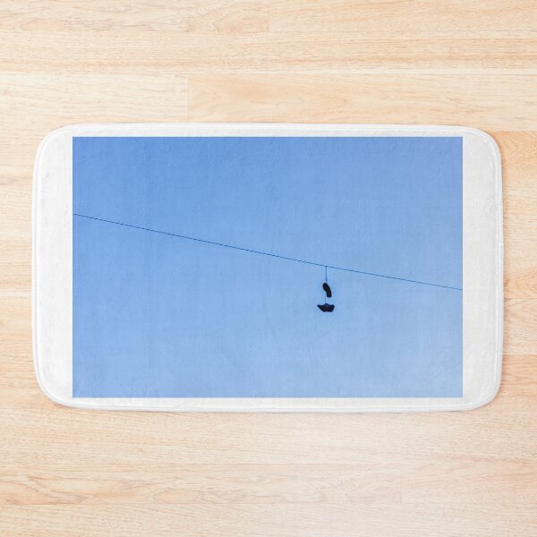 Item preview, Shoes Hanging on a Wire Against a Clear Blue Sky in Open Air designed and sold by Nmallia.