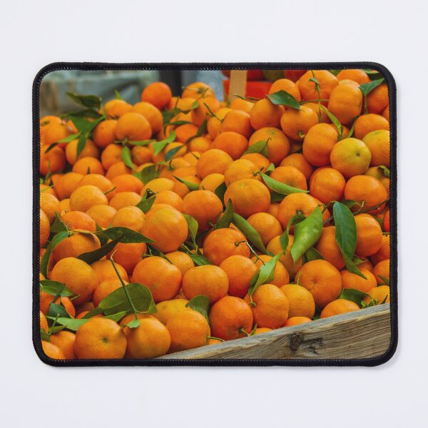 Item preview, Fresh Oranges Piled in a Wooden Crate at Market With Bright Green Leaves designed and sold by Nmallia.