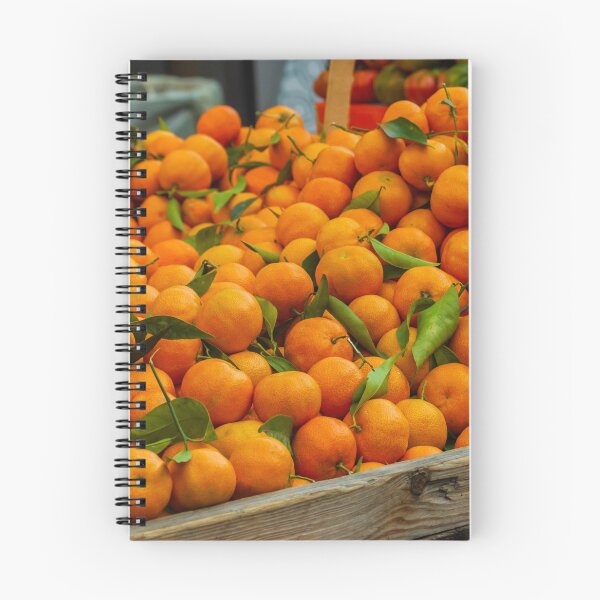 Item preview, Fresh Oranges Piled in a Wooden Crate at Market With Bright Green Leaves designed and sold by Nmallia.