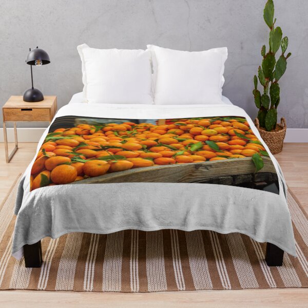 Item preview, Fresh Oranges Piled in a Wooden Crate at Market With Bright Green Leaves designed and sold by Nmallia.